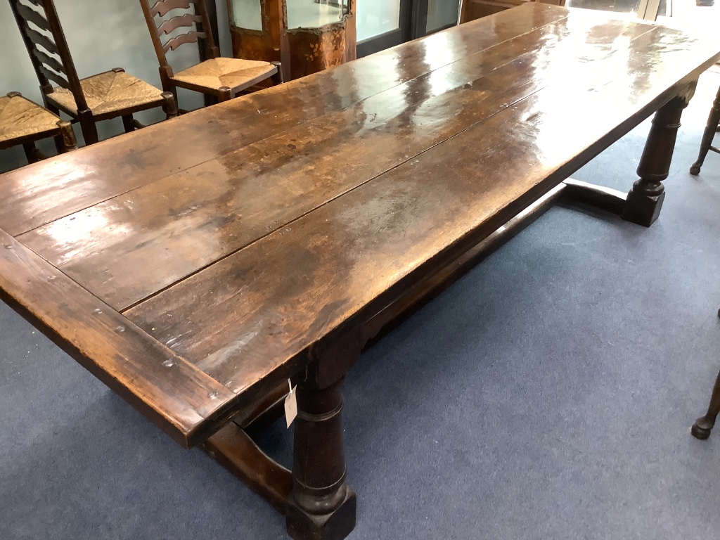 An 18th century style oak refectory dining table, length 274cm, width 94cm, height 72cm